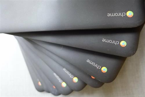 Pile of Chromebooks with a Chrome icon 