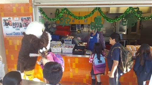 Ernie picking which food he wants in the lunch line 